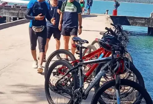 Cyclists arriving at the pier on Koh Yao Noi island, ready to begin their guided cycling tour with Phuket Travel Store