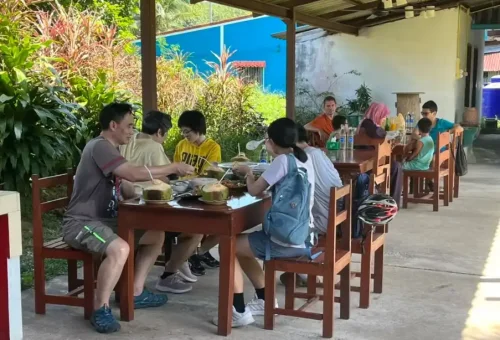 Customers enjoying lunch together at a local restaurant during the Koh Yao Noi cycling tour with Phuket Travel Store