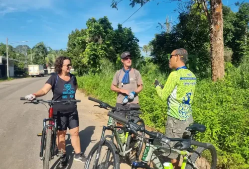 Biking guide explaining local sights and route details to guests during the Koh Yao Noi cycling tour with Phuket Travel Store
