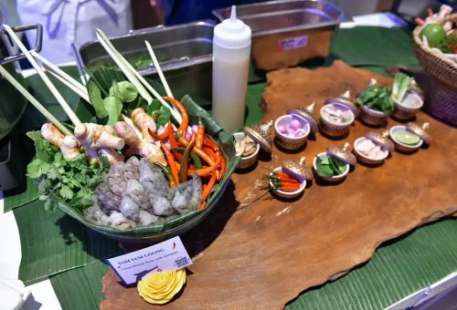 A wide variety of fresh Thai ingredients neatly arranged in the kitchen at Blue Elephant Cooking School Phuket, ready for cooking class.