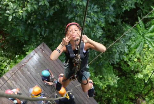 Family enjoying an exciting zipline adventure together at Flying Hanuman, soaring above the jungle canopy in Phuket