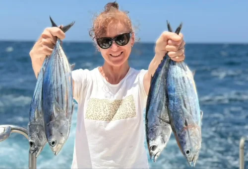 Joyful customer showing off their impressive fish catch on a trolling and game fishing boat in the waters around Phuket