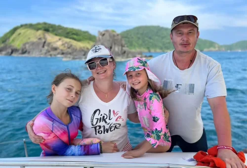 Happy traveler in a speedboat heading to Raya Island with Phuket Travel Store – enjoying tropical sea adventure.