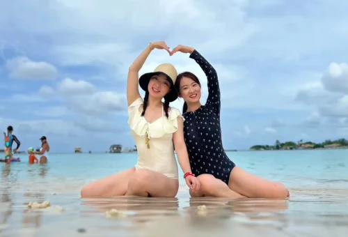 Raya Island Coral Island Phuket Travel Store – tranquil tropical beach scene with soft sand and clear blue waters.