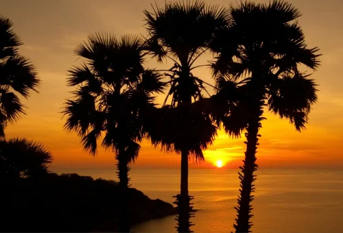 Sunset view from Promthep Cape with vibrant sky over the sea in Phuket.