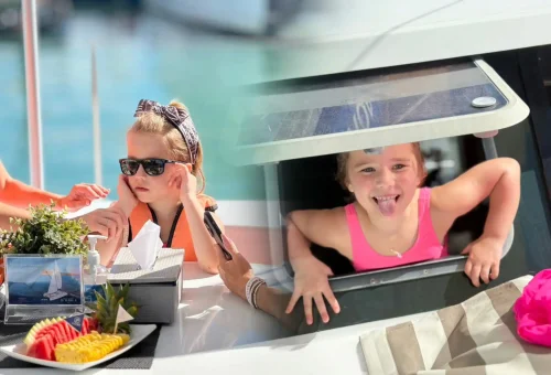Group of smiling travelers enjoying the ocean breeze and scenic views aboard a luxury sailing cruise near Racha and Coral Islands in Phuket.