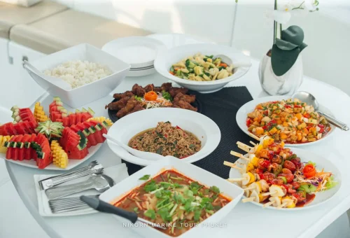Guests laughing and enjoying the relaxing atmosphere on a luxury sailing yacht headed to Racha and Coral Islands, Phuket.