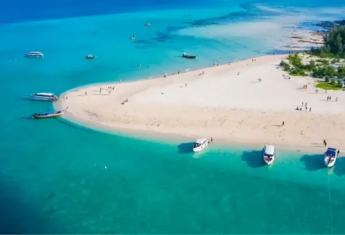 Aerial view of Khai Nai Island with white sandy beach and turquoise water, captured during the Phi Phi Island speed catamaran tour by Phuket Travel Store