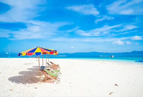 Snow-white sandy beach and clear turquoise water at Khai Nai Island, part of the Phi Phi Island speed catamaran tour by Phuket Travel Store