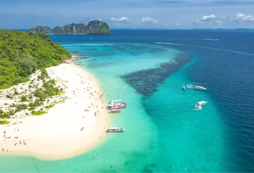 Aerial view of Bamboo Island surrounded by turquoise sea, soft white beaches, and lush greenery, featured on the Phi Phi Island speed catamaran tour by Phuket Travel Store