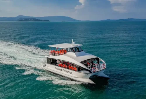 Modern speed catamaran cruising through turquoise waters en route to Phi Phi Island, part of the tour offered by Phuket Travel Store