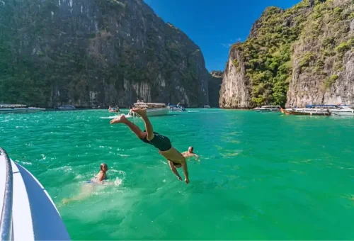 Pileh Lagoon at Phi Phi Leh Island with emerald green water surrounded by limestone cliffs, featured on the Phi Phi Island speed catamaran tour by Phuket Travel Store