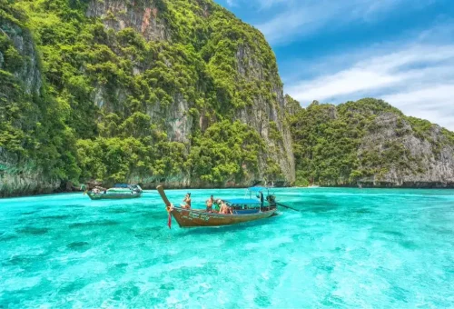 Pileh Lagoon at Phi Phi Leh Island with clear emerald water surrounded by steep limestone cliffs, captured during the speed catamaran tour by Phuket Travel Store