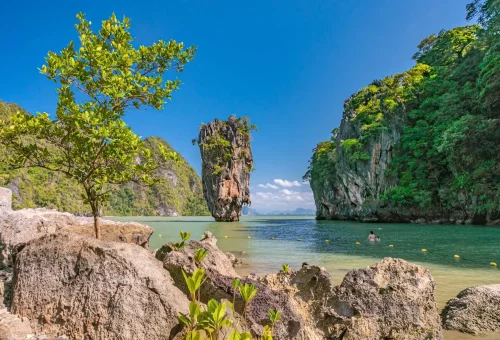 View of James Bond Rock in Phang Nga Bay with iconic limestone cliff surrounded by emerald waters – PhuketTravelStore.com