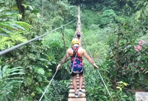Adventure seeker enjoying a high-speed zipline ride over Phuket’s jungle with Anda Adventure – PhuketTravelStore.com