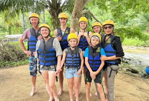 Group enjoying white water rafting adventure in Phang Nga with Anda Adventure – surrounded by lush jungle – PhuketTravelStore.com