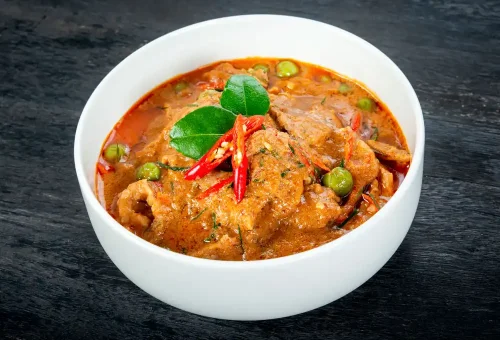 Spicy Red Curry with chicken from Kata Thai Cooking Class in Phuket – rich Thai curry with coconut milk, herbs, and chili paste.