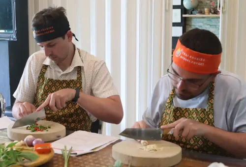 Customer preparing fresh Thai ingredients at Kata Thai Cooking Class in Phuket