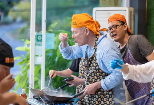Customer tasting freshly made Thai food at Kata Thai Cooking Class in Phuket