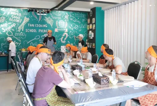Thai chef explaining cooking steps during a class at Kata Thai Cooking Class in Phuket