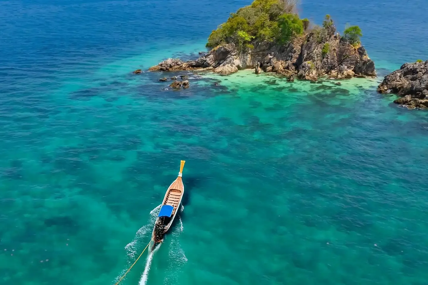 Snorkelers exploring vibrant coral reefs at Khai Nui Island near Phuket