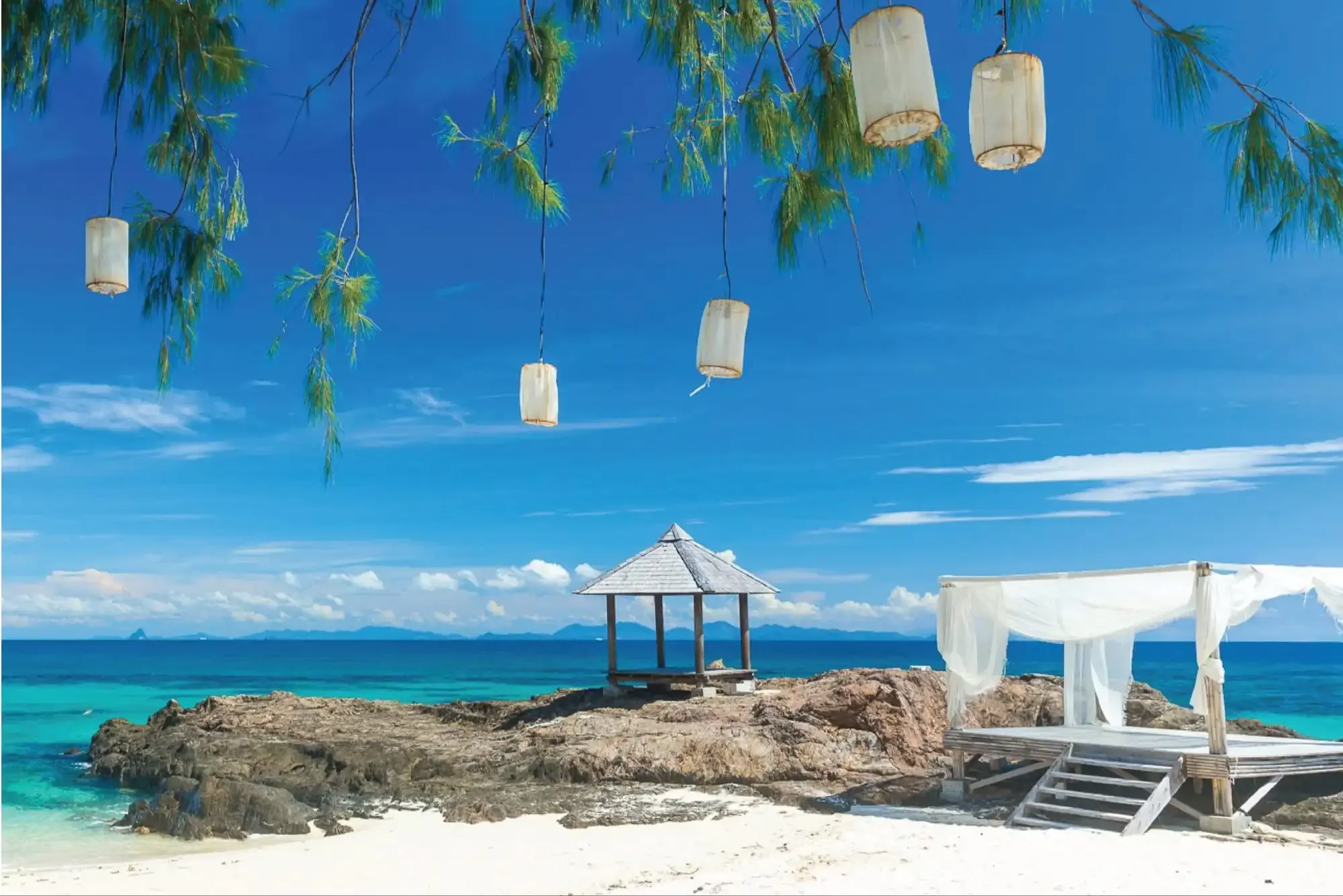 Elegant wedding sala by the beach at Maiton Island, surrounded by palm trees and overlooking the turquoise sea