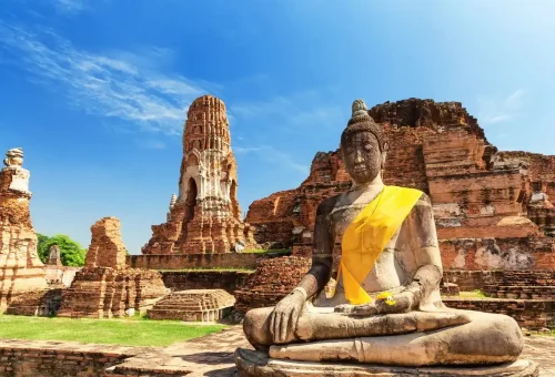 Ancient Buddha statue and temple ruins at Ayutthaya Historical Park, Thailand – a must-visit heritage site with Phuket Travel Store