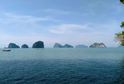 Scenic view of limestone cliffs and calm emerald waters in Phang Nga Bay, Thailand