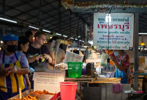 Evening shoppers at Chillva Market browsing handmade jewelry and crafts