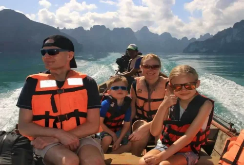Panoramic view of Cheow Lan Lake with lush jungle and towering limestone cliffs in Khao Sok National Park on a two-day wildlife experience