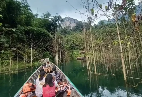 Scenic longtail boat ride on Cheow Lan Lake in Khao Sok National Park with Phuket Travel Store during a two-day wildlife tour