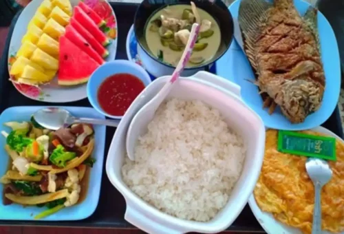 Traditional Thai dishes served in a rustic jungle setting at Khao Sok National Park with Phuket Travel Store.