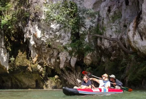 Peaceful canoeing experience on the Sok River at Khao Sok National Park with Phuket Travel Store, surrounded by lush jungle and towering cliffs.