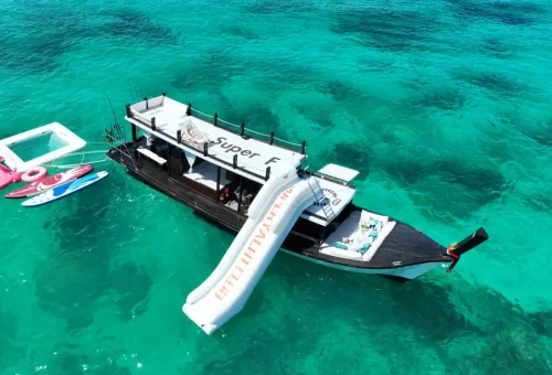 Elegant woodwork and cushioned seating inside Super-F boat in Phuket