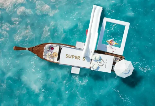 Elegant Super-S longtail boat sailing near Phuket with satisfied guests onboard