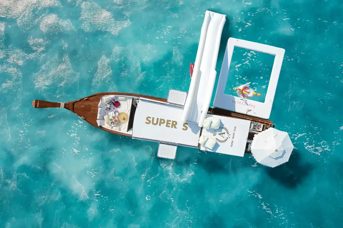 Elegant Super-S longtail boat sailing near Phuket with satisfied guests onboard