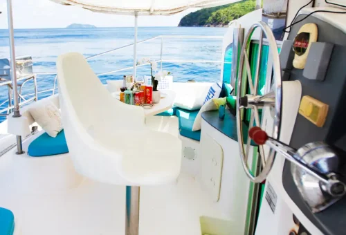 Super-V sailing catamaran anchored near a tropical island with Phuket Travel Store