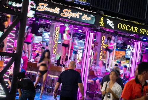 Tourists walking along lively Bangla Road in Phuket by night