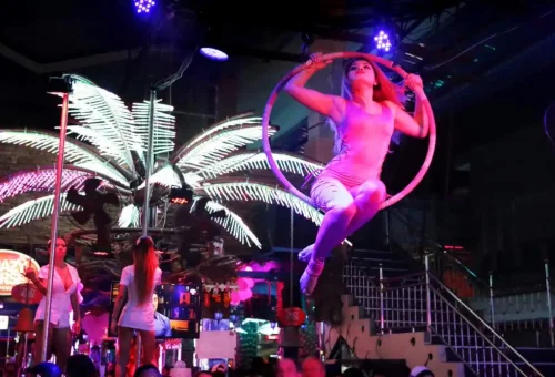 People enjoying bars and street shows on Bangla Road in Phuket