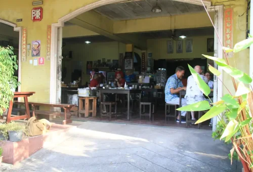 Friendly locals greeting visitors in Takuapa