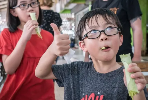 Traveler exploring Ayutthaya's ancient ruins and tasting traditional Thai food on the Ancient Ayutthaya Food & History Tour