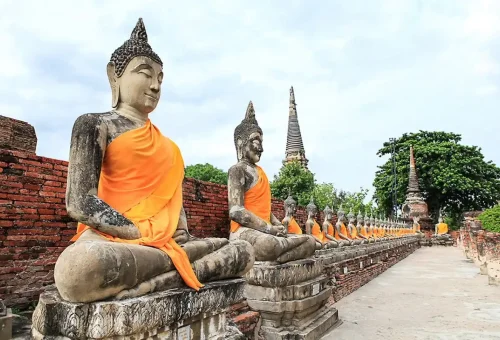 Visitor enjoying pad thai while exploring Wat Yai Chai Mongkhon and trying Thai desserts