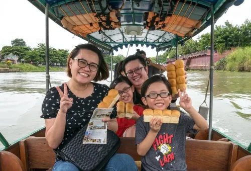 Visitor enjoying boat noodles while exploring Wat Mahathat and learning about Siamese history