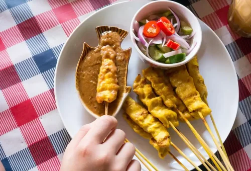 Visitor enjoying roti sai mai while exploring Wat Chaiwatthanaram and trying Thai desserts