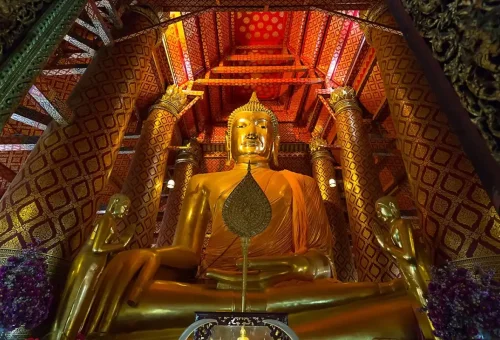 Visitor enjoying roti sai mai while exploring Wat Chaiwatthanaram and exploring UNESCO World Heritage ruins