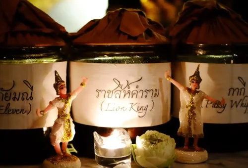 Tourist smiling while holding a drink inside a tuk tuk during Bangkok bar crawl night tour