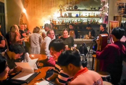 Bartender mixing Thai-inspired cocktails at a hidden Bangkok speakeasy