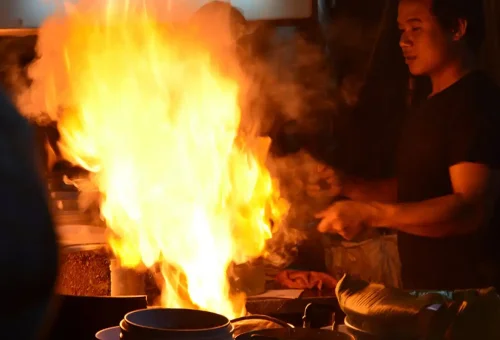Guest enjoying coconut ice cream at Charoen Krung Road during Bangkok Midnight Food Tour by Tuk Tuk with Phuket Travel Store
