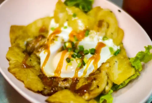 Guest enjoying Thai iced tea at Saphan Phut Night Market during Bangkok Midnight Food Tour by Tuk Tuk with Phuket Travel Store