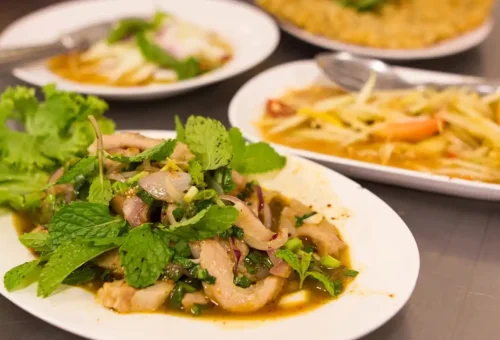 Guest enjoying Thai-style sukiyaki at Talad Noi during Bangkok Midnight Food Tour by Tuk Tuk with Phuket Travel Store